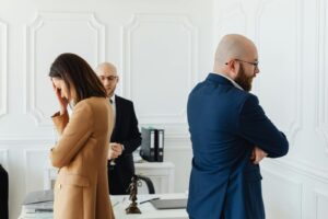 Tense office atmosphere with professionals showing emotions in modern workplace.